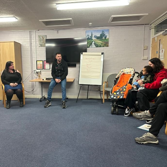 A facilitator talking with a group