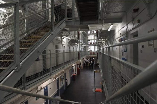 A prison wing with landings and stairways