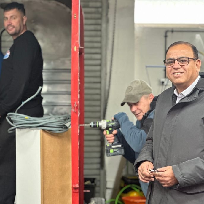 A visitor smiling in the workshop